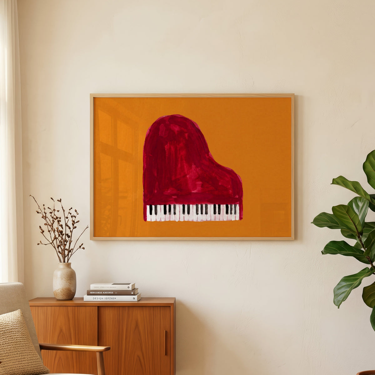Orange and red piano print in an oak frame above a teak sideboard beside a fig tree