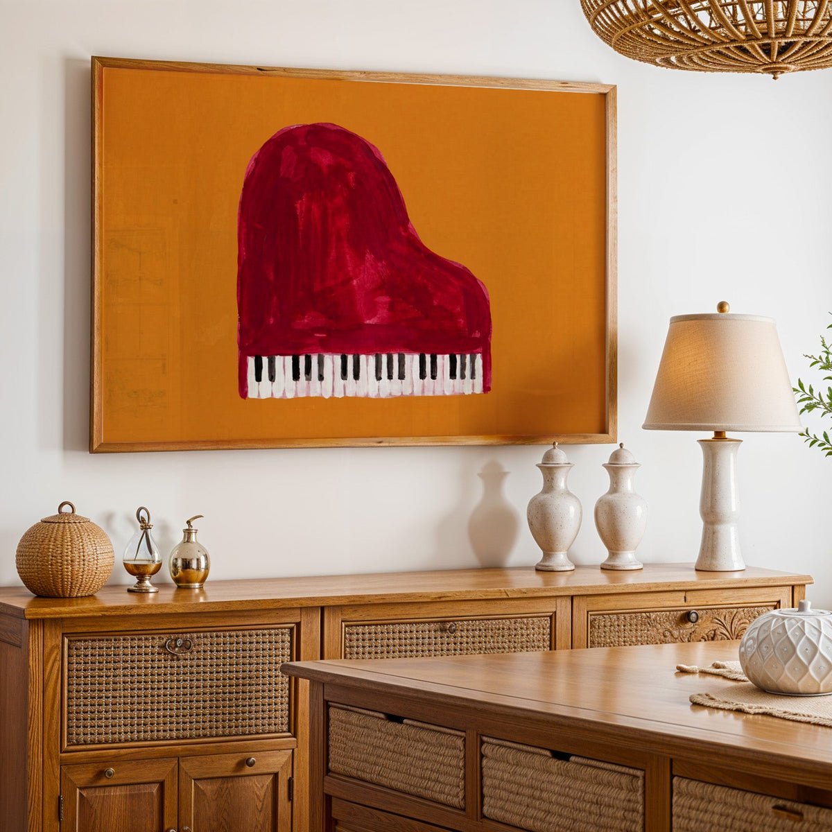 Piano music wall art print in an oak frame above a cane sideboard with a table lamp
