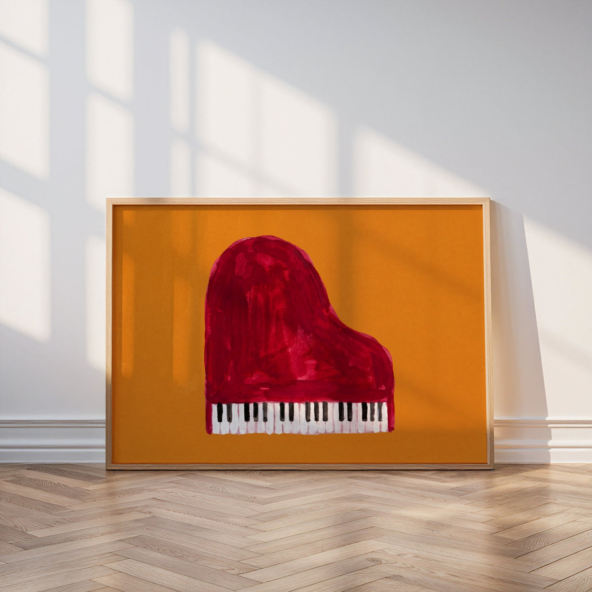 Hand-painted piano print in an oak frame leaning on a parquet floor in window light