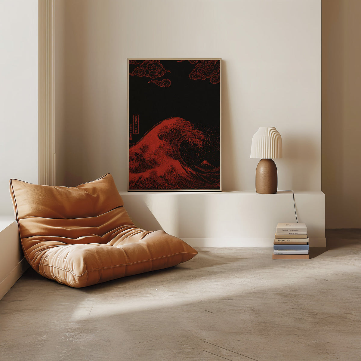 red Great Wave on black print in a light oak frame on a white ledge by a tan leather floor chair