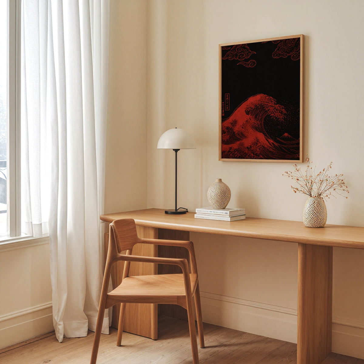 red Great Wave on black print in an oak frame above a long oak desk with a white dome lamp and woven vases
