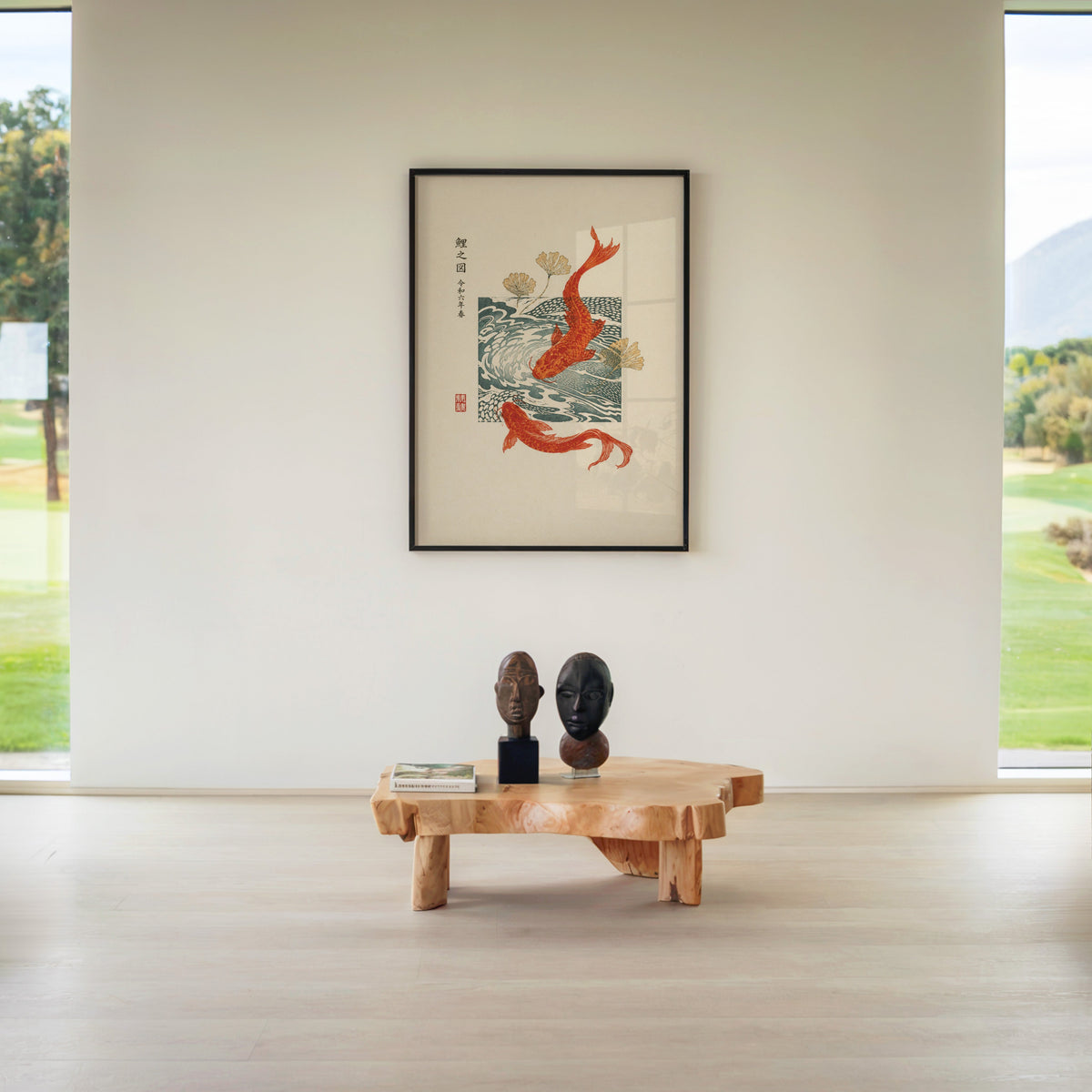 red koi with ginkgo and wave block print in a black frame above a live-edge wood coffee table between garden windows