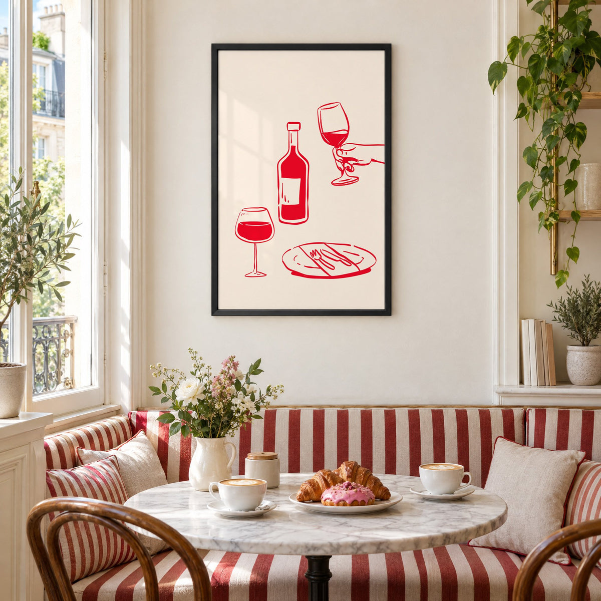 Red line wine bottle and dinner table print in a black frame above a striped cafe breakfast nook with cappuccino and pastries
