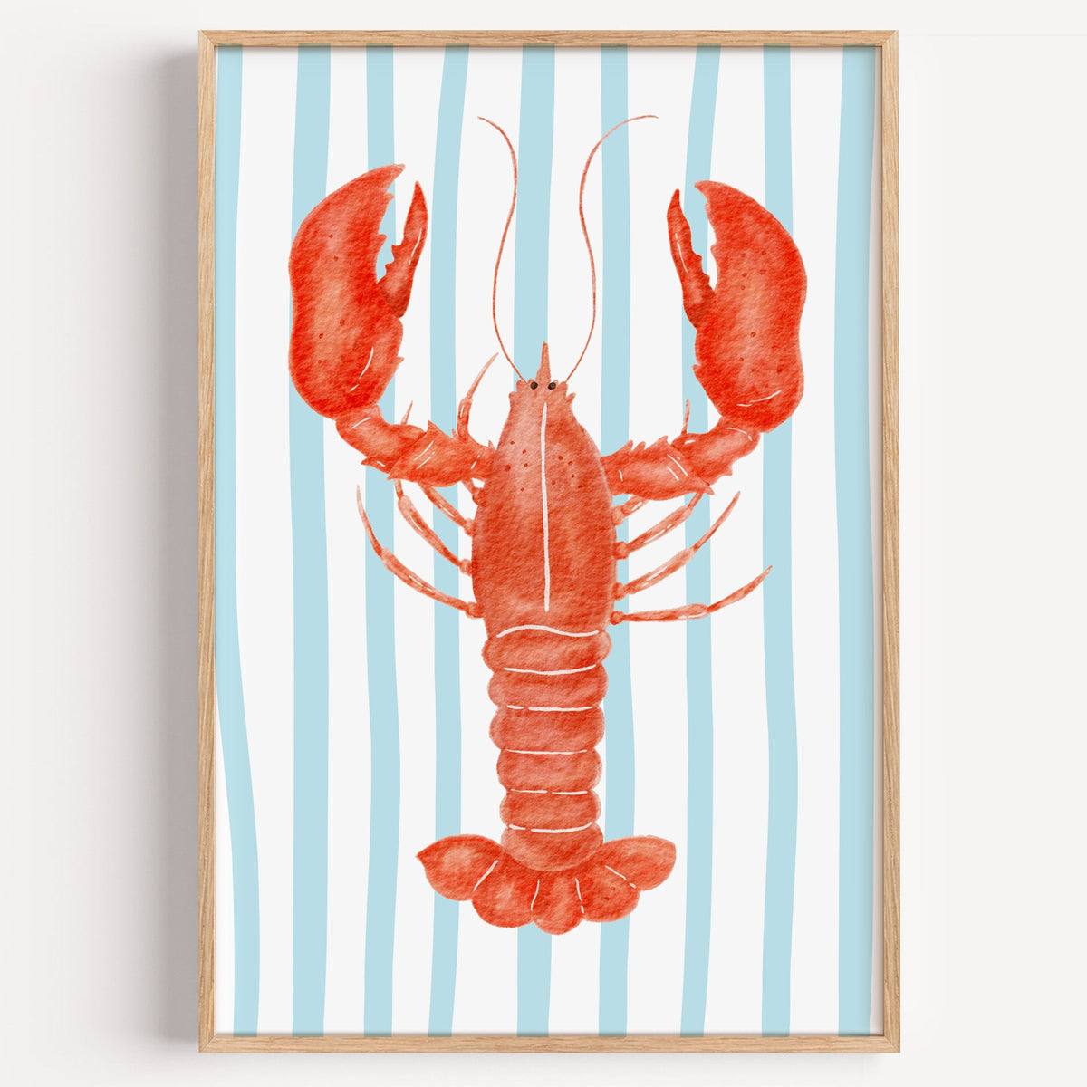 Red lobster blue stripe print in a light oak frame on a plain white wall