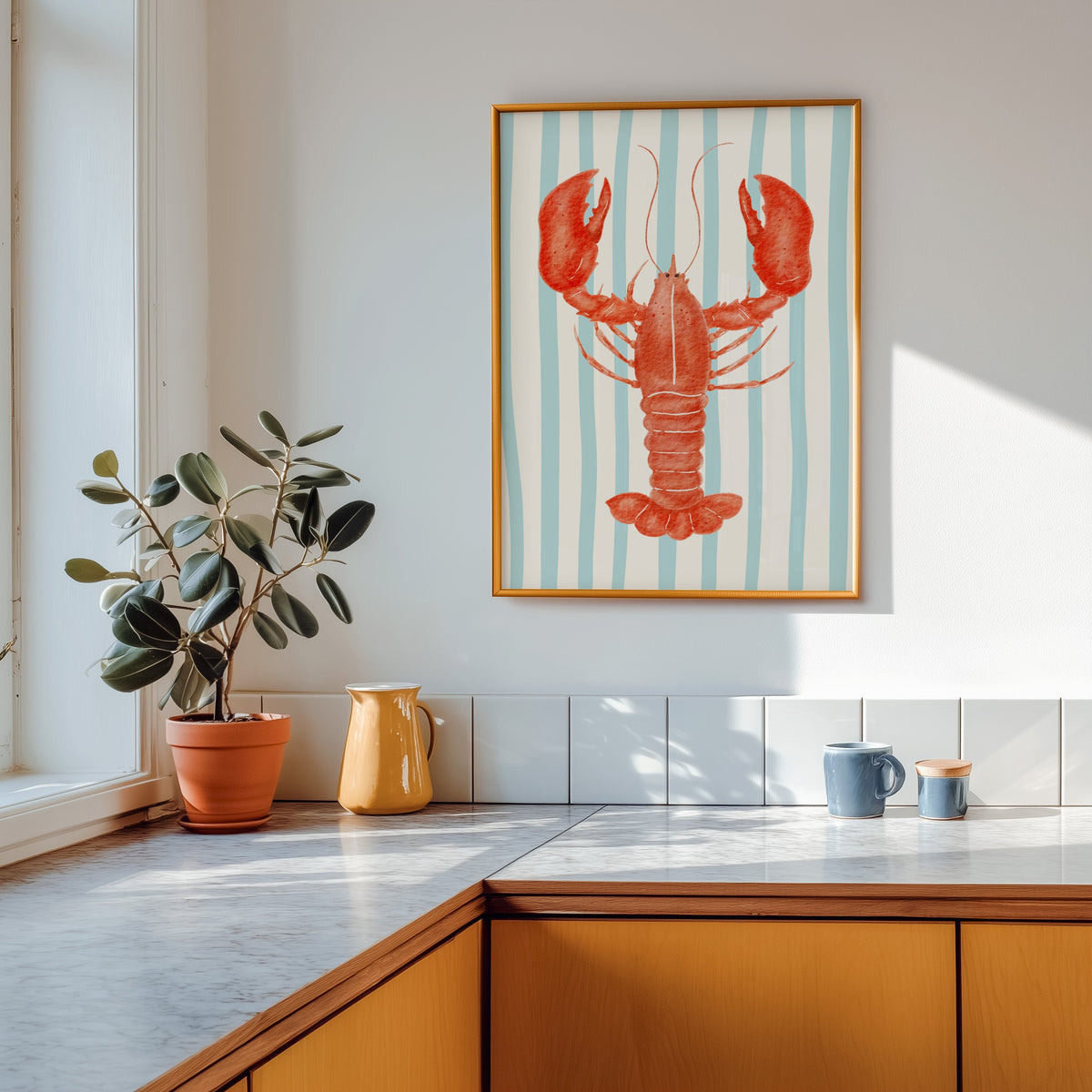 Red lobster print shown in a gold frame above a marble counter with a yellow ceramic jug