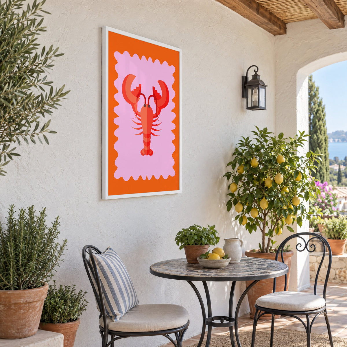 Red lobster pink wavy frame print in a white frame on a sunny patio wall beside a potted lemon tree