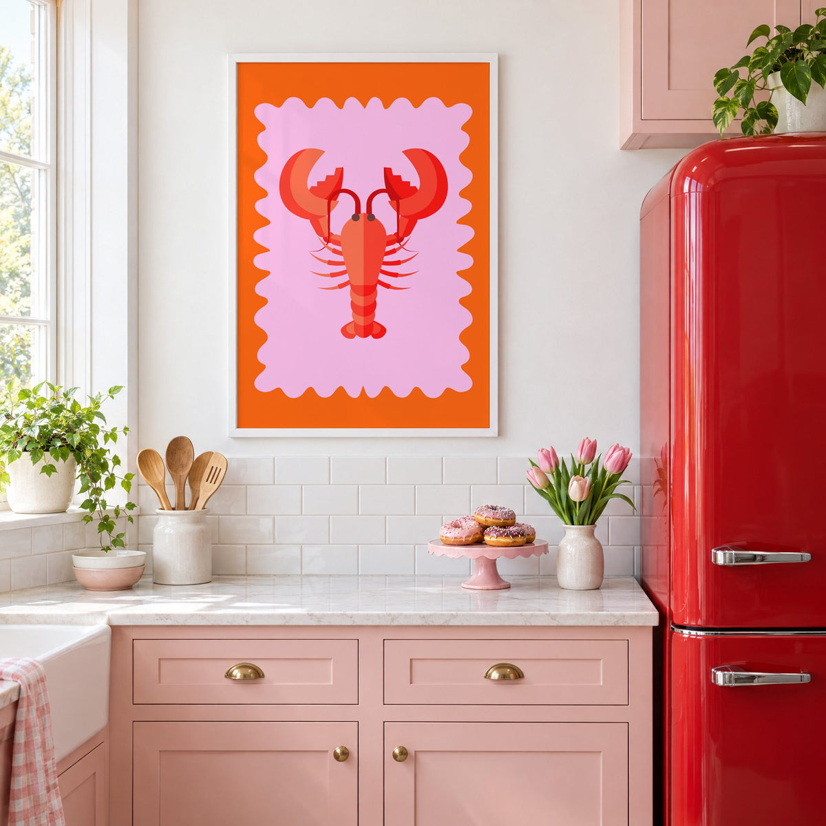 Red lobster pink wavy frame print in a white frame in a pink kitchen beside a red retro fridge