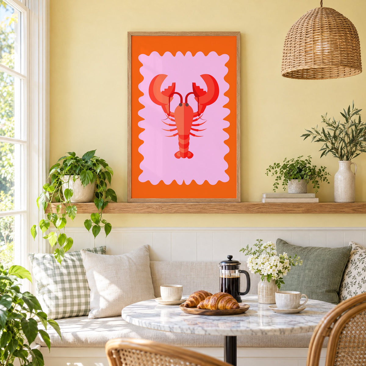 Red lobster pink wavy frame print in an oak frame on a picture ledge above a sunny breakfast nook