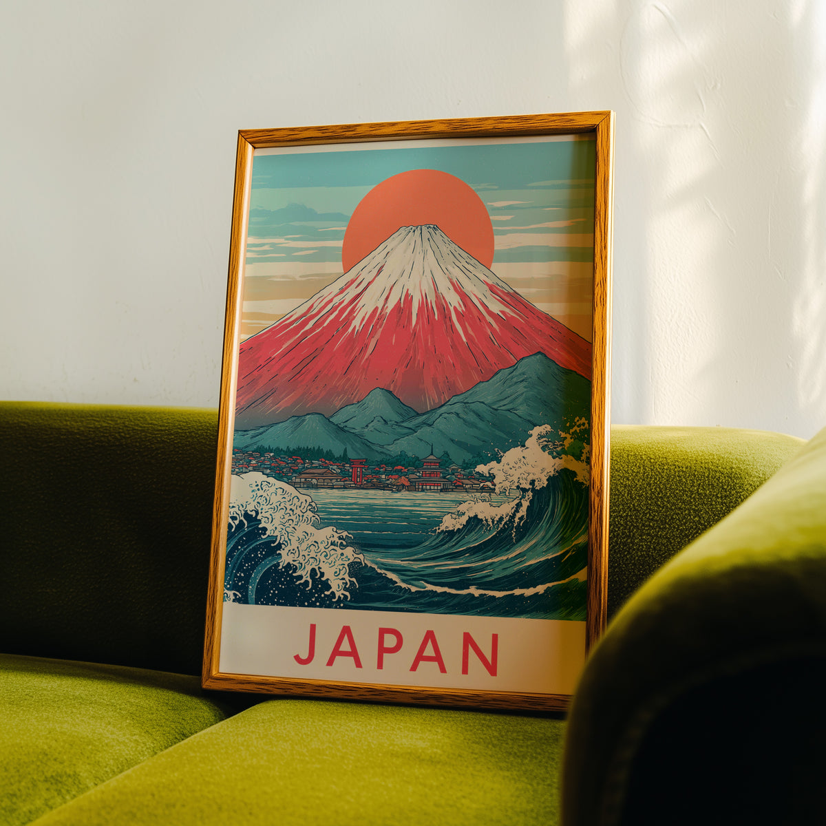 Red Mount Fuji navy wave print in an oak frame propped on a green velvet sofa