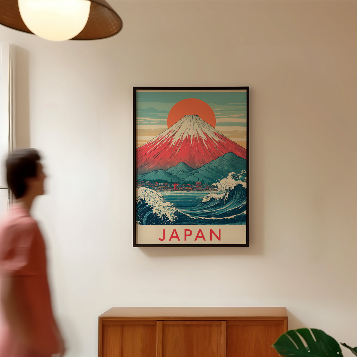 Red Mount Fuji navy wave print in a black frame in a hallway under a rattan pendant