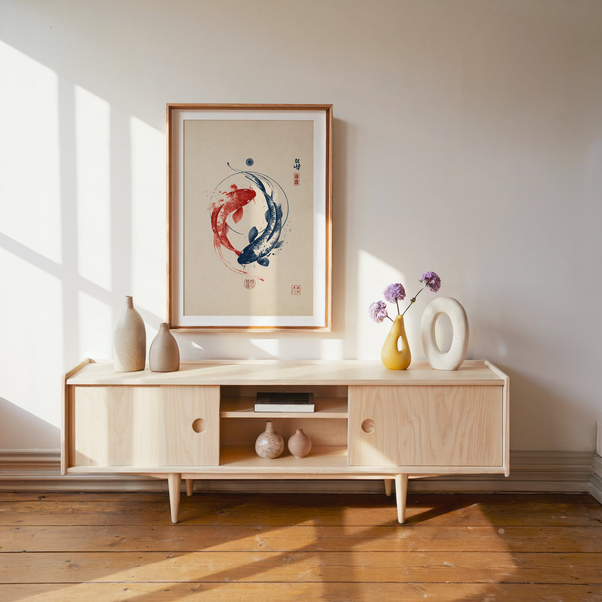 red and navy koi in a circle print shown in a wood frame with a white mat above a pale wood media console