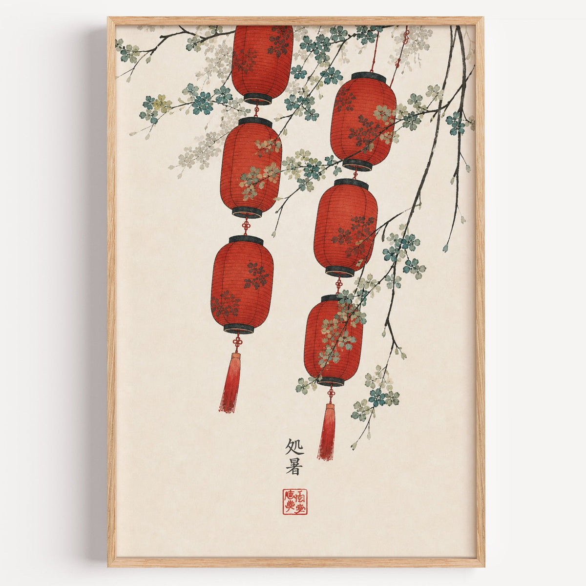 red paper lanterns with blossom branch print in a light oak frame on a plain white wall