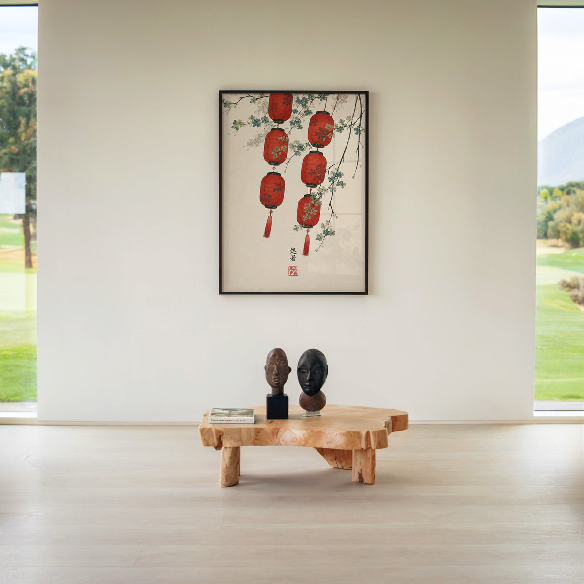 red paper lanterns with blossom branch print in a black frame above a live-edge wood coffee table between garden windows
