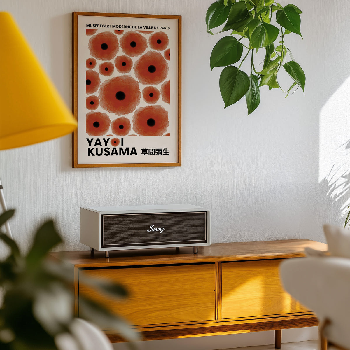 Yayoi Kusama inspired red poppy dot print above a sideboard with a plant