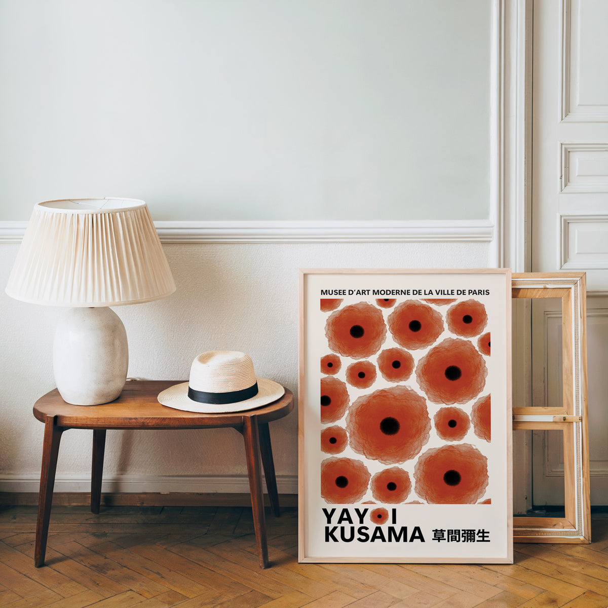 Yayoi Kusama inspired red poppy dot print beside a bench and straw hat