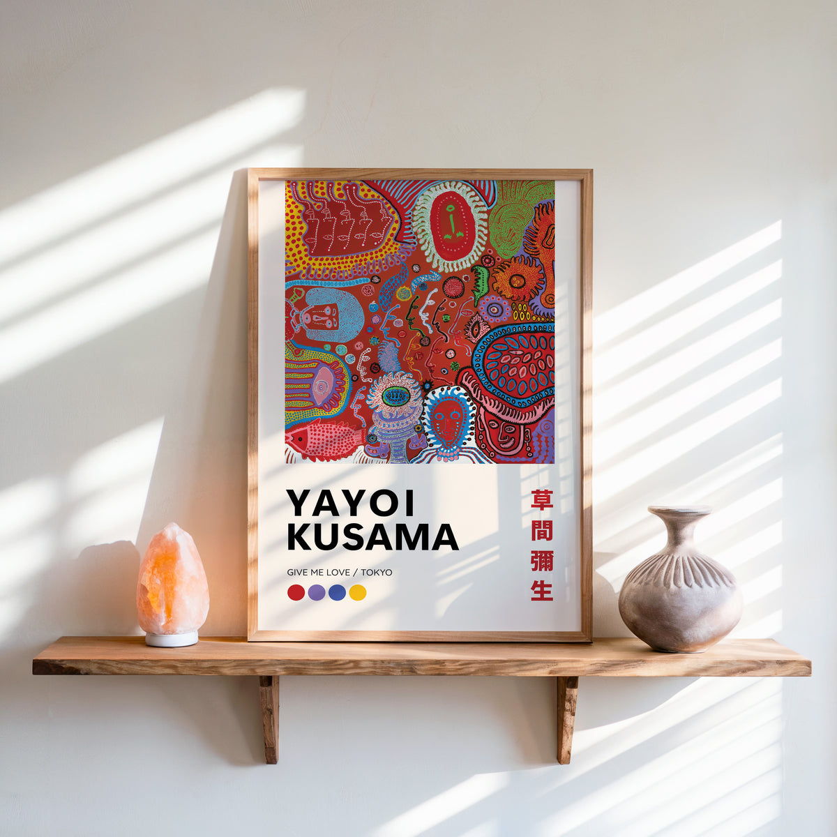 Yayoi Kusama inspired red psychedelic faces print above a shelf with a salt lamp