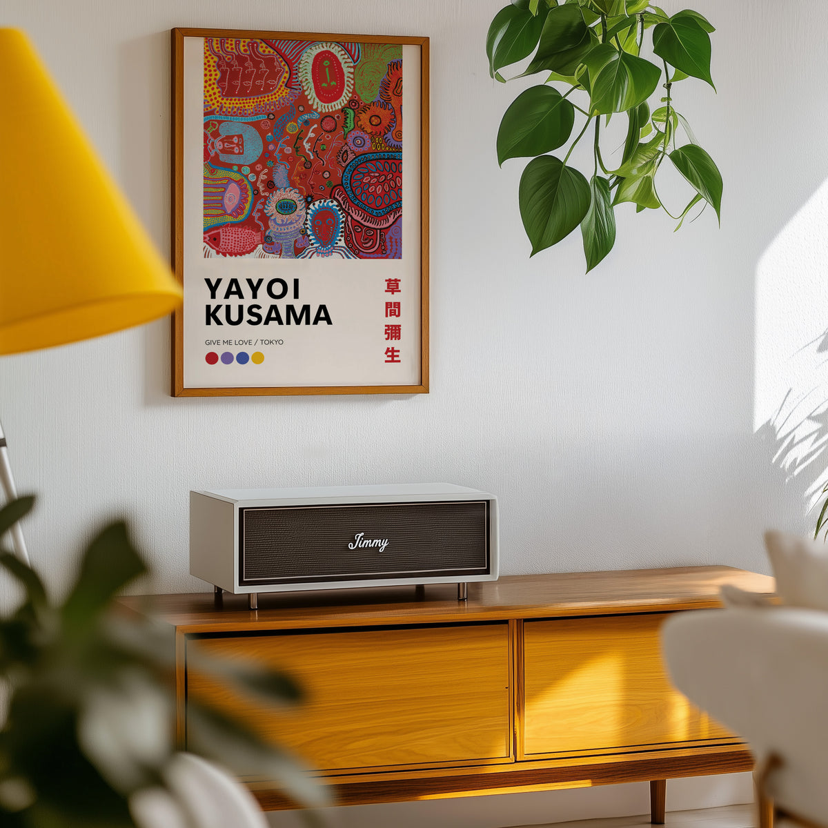 Yayoi Kusama inspired red psychedelic faces print above a sideboard with a plant