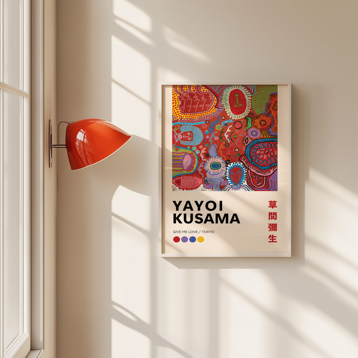 Yayoi Kusama inspired red psychedelic faces print in a white frame by a red wall lamp