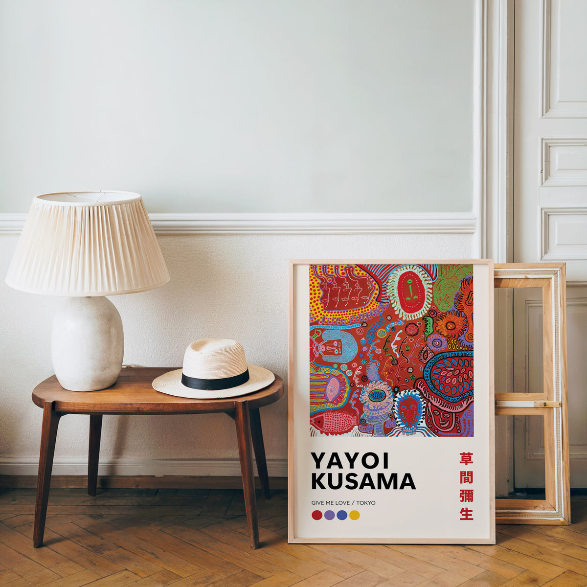 Yayoi Kusama inspired red psychedelic faces print beside a bench and straw hat