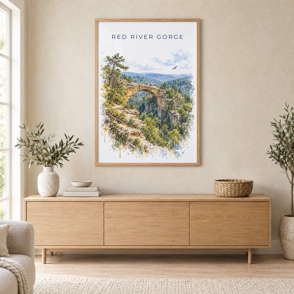 Red River Gorge watercolor print in an oak frame above a light wood sideboard in a Scandinavian living room