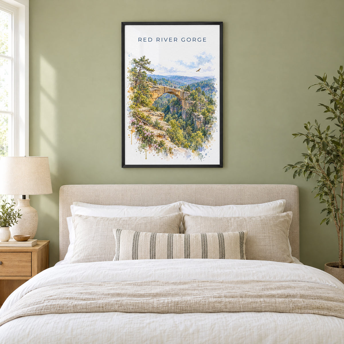 Red River Gorge watercolor print in a black frame above an upholstered headboard in a sage green bedroom