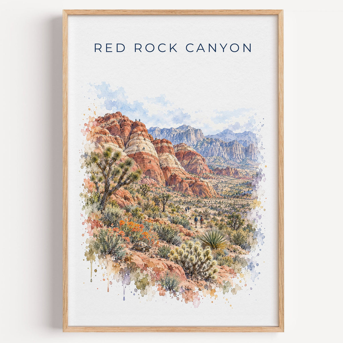 Red Rock Canyon National Conservation Area watercolor print in a light oak frame on a plain white wall