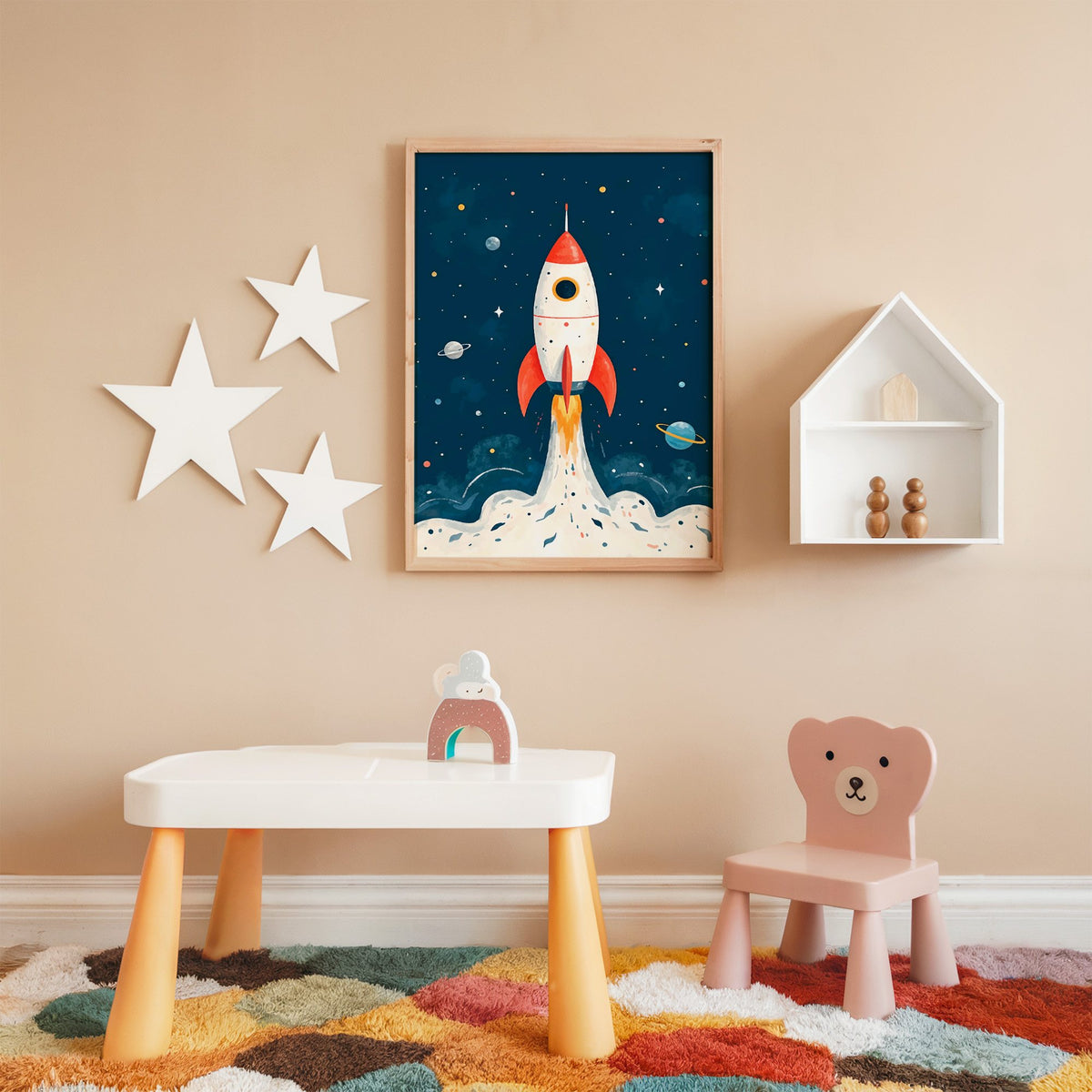 Red rocket launching past planets nursery print in an oak frame on a peach wall above a kids table with wall stars
