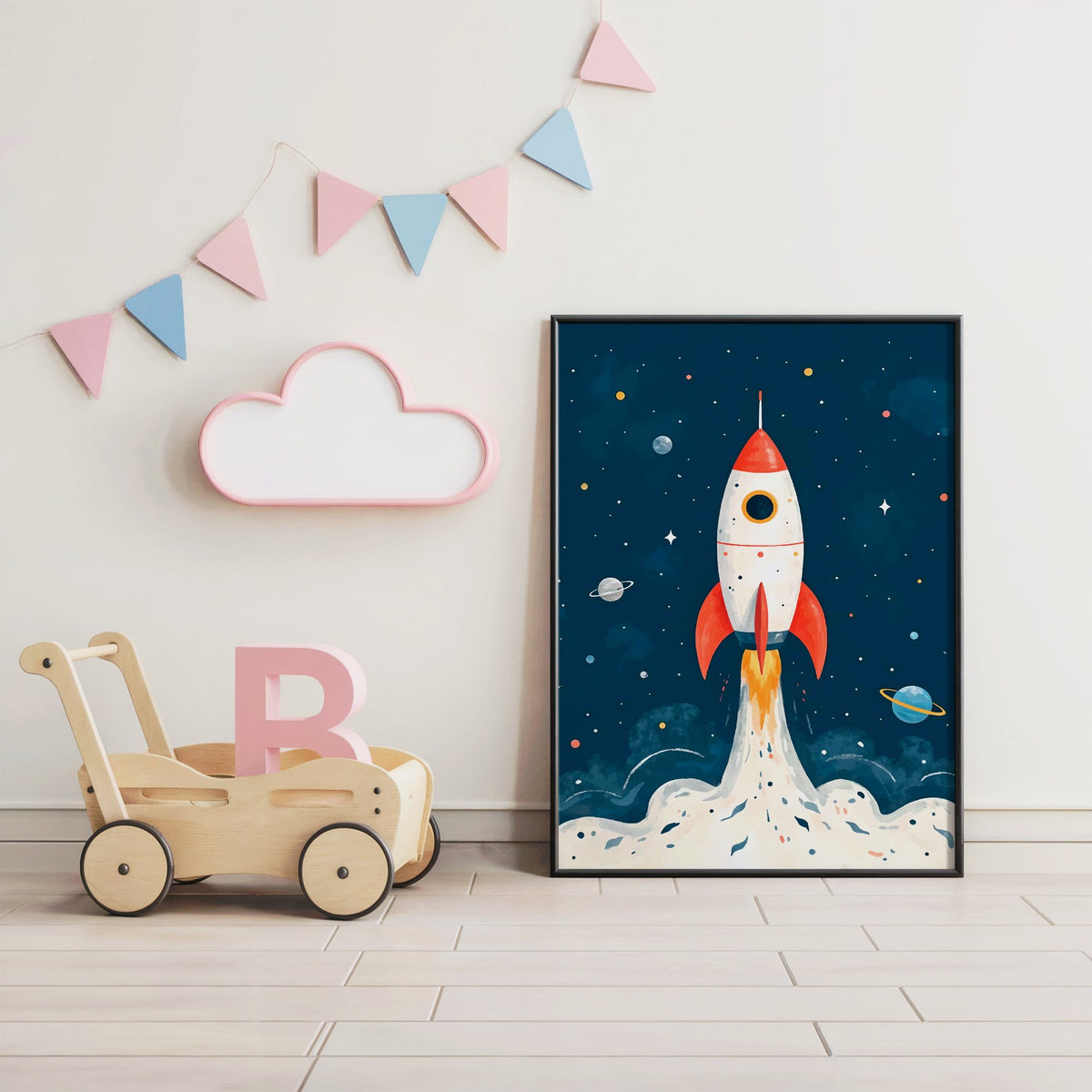 Red rocket launching past planets nursery print in a black frame under pastel bunting by a wooden baby walker