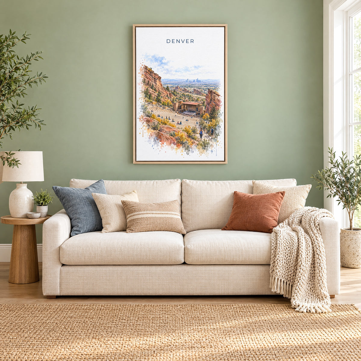 Red Rocks Amphitheatre watercolor print as a natural floater canvas above a cream linen sofa on a sage green wall