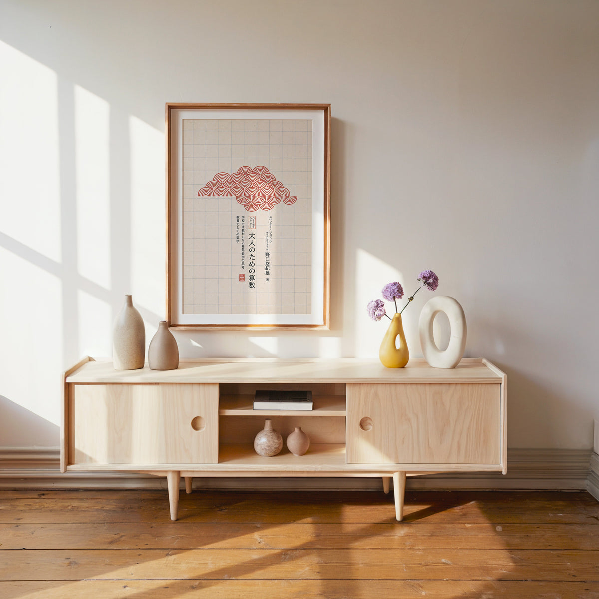 red seigaiha cloud on grid paper print shown in a wood frame with a white mat above a pale wood media console