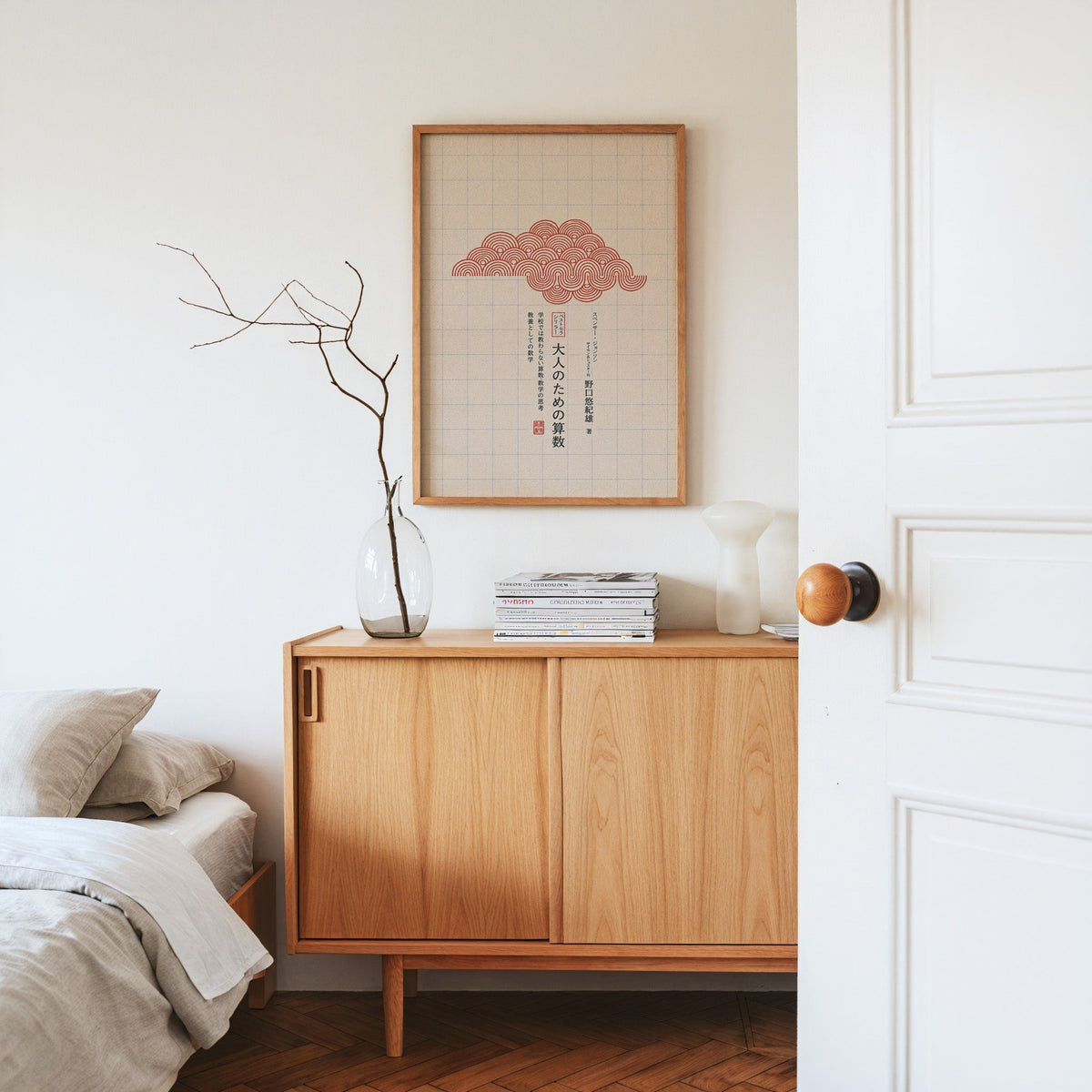 red seigaiha cloud on grid paper print in an oak frame above an oak sideboard in a bedroom with linen bedding