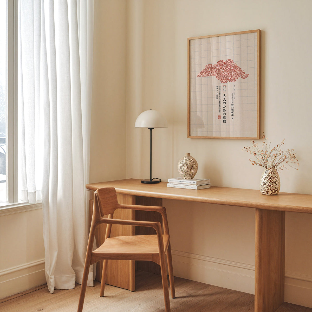 red seigaiha cloud on grid paper print in an oak frame above a long oak desk with a white dome lamp and woven vases