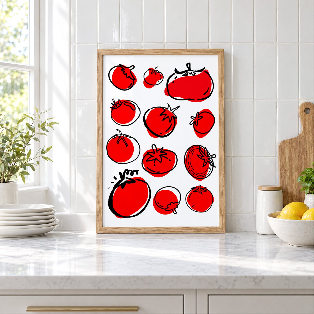 Red tomatoes ink sketch print in an oak frame leaning on a marble counter by white tiles and lemons
