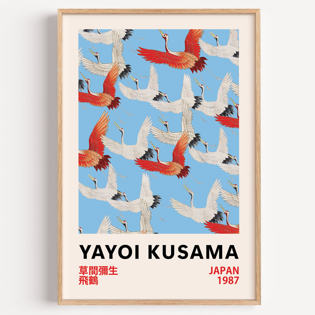 Yayoi Kusama inspired red and white flying cranes print on a plain white wall