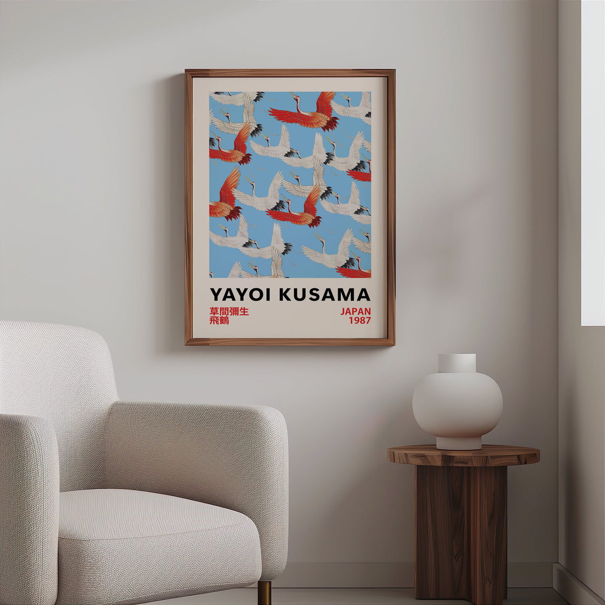 Yayoi Kusama inspired red and white flying cranes print in a walnut frame above a boucle armchair