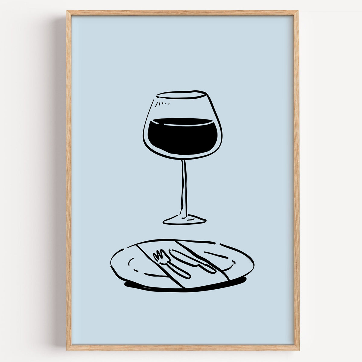 Red wine glass line print in a light oak frame on a plain white wall