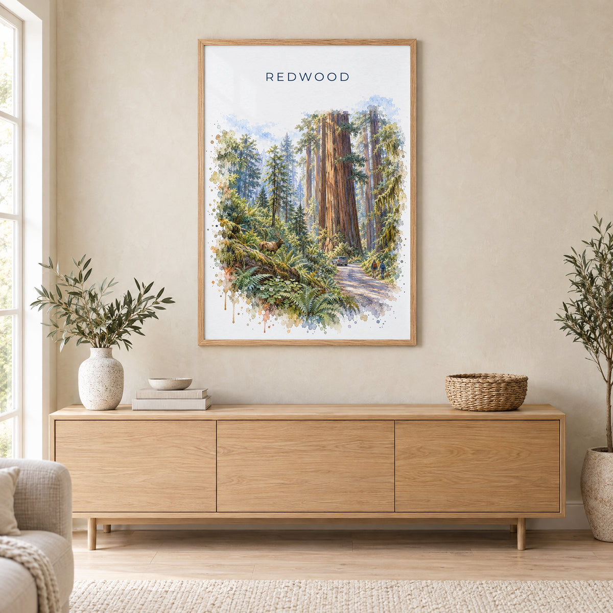 Redwood National Park watercolor print in an oak frame above a light wood sideboard in a Scandinavian living room