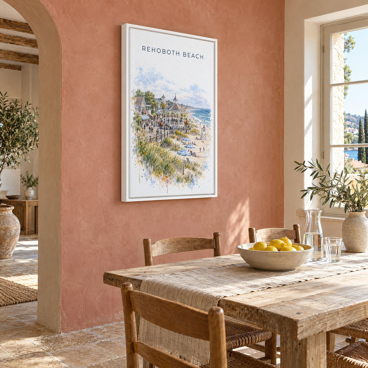 Rehoboth Beach watercolor print as a white floater canvas on a terracotta wall above a rustic dining table