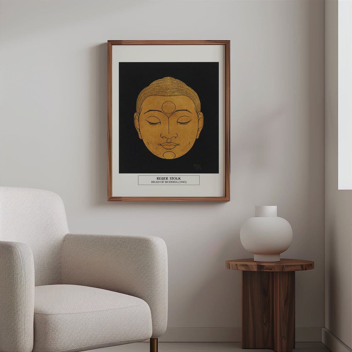 Gold Buddha line print in a slim walnut frame above a bouclé armchair