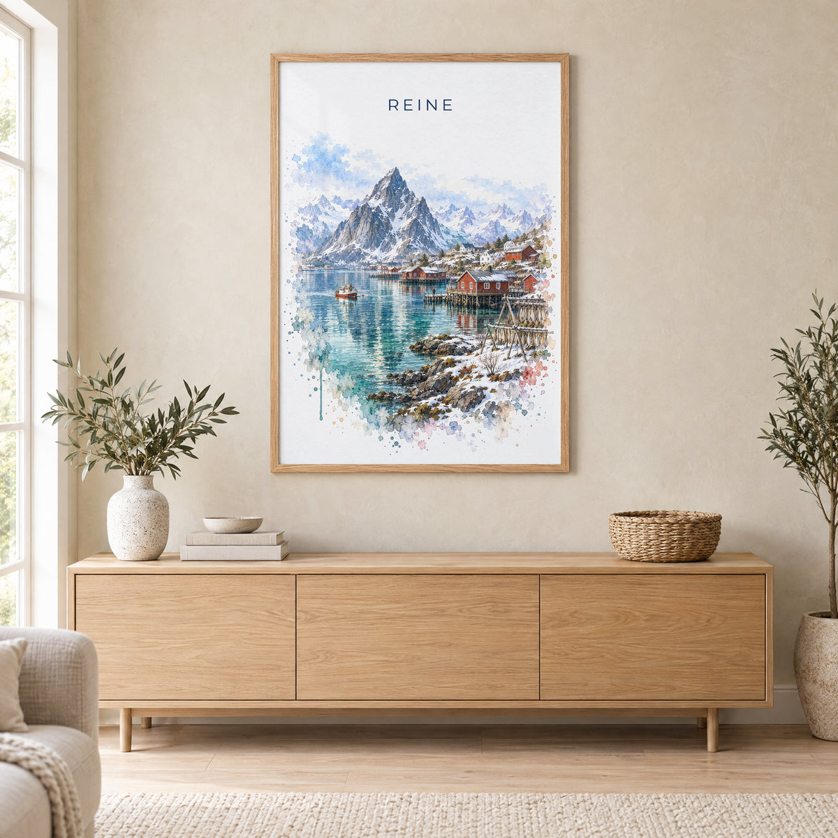 Reine, Norway watercolor print in an oak frame above a light wood sideboard in a Scandinavian living room