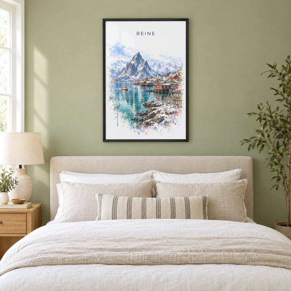Reine, Norway watercolor print in a black frame above an upholstered headboard in a sage green bedroom