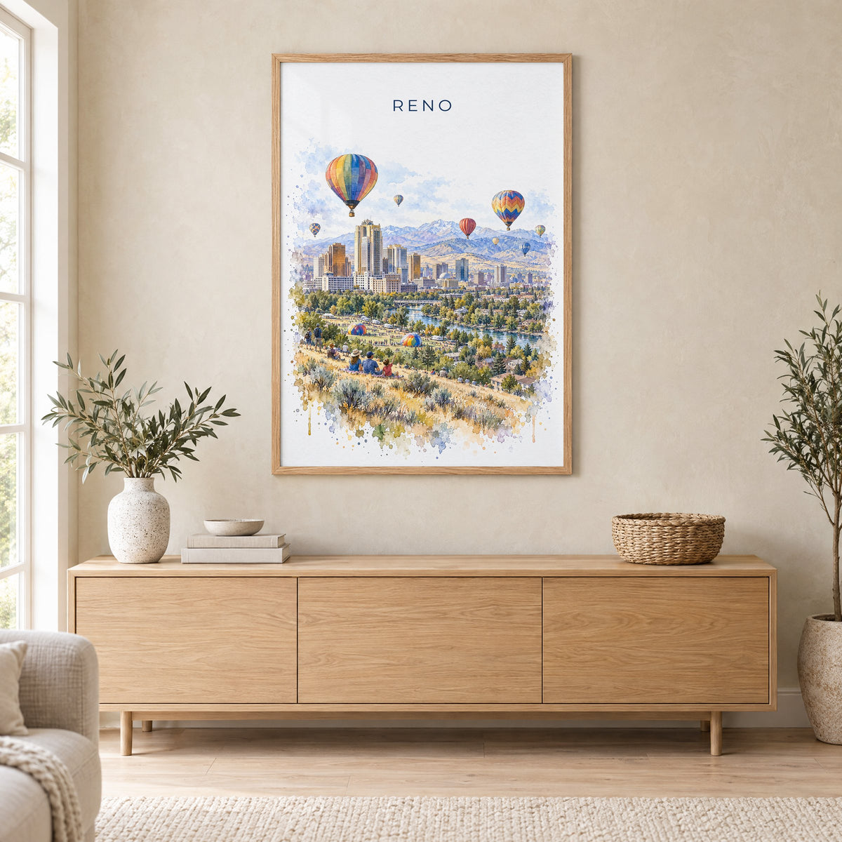 Reno, Nevada watercolor print in an oak frame above a light wood sideboard in a Scandinavian living room