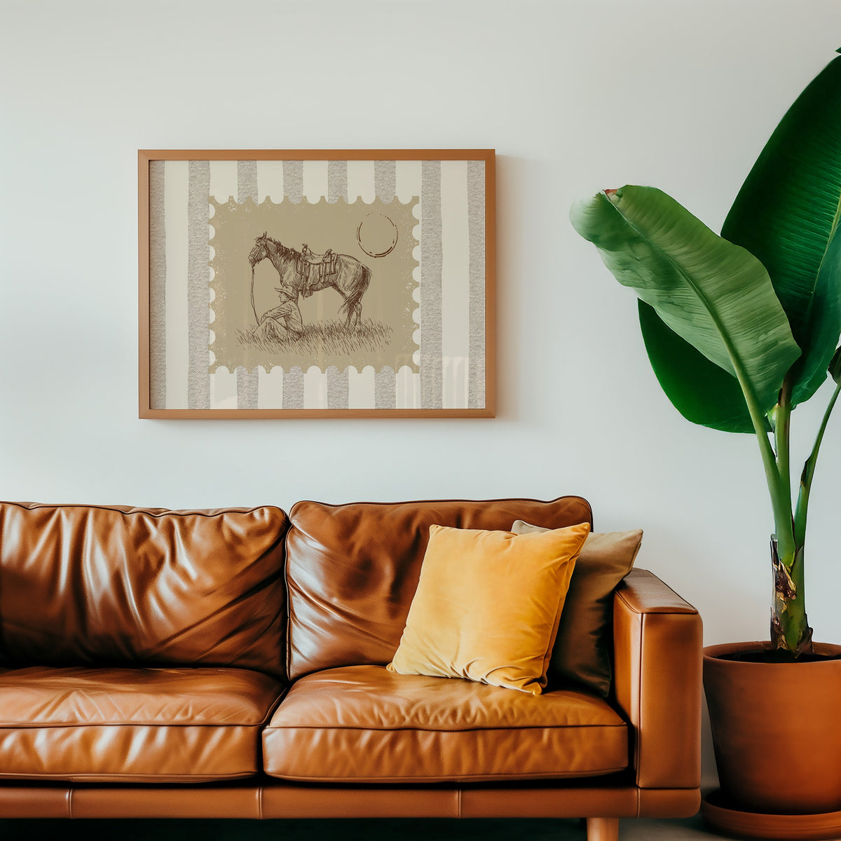 Resting horse stamp print in an oak frame above a cognac leather sofa