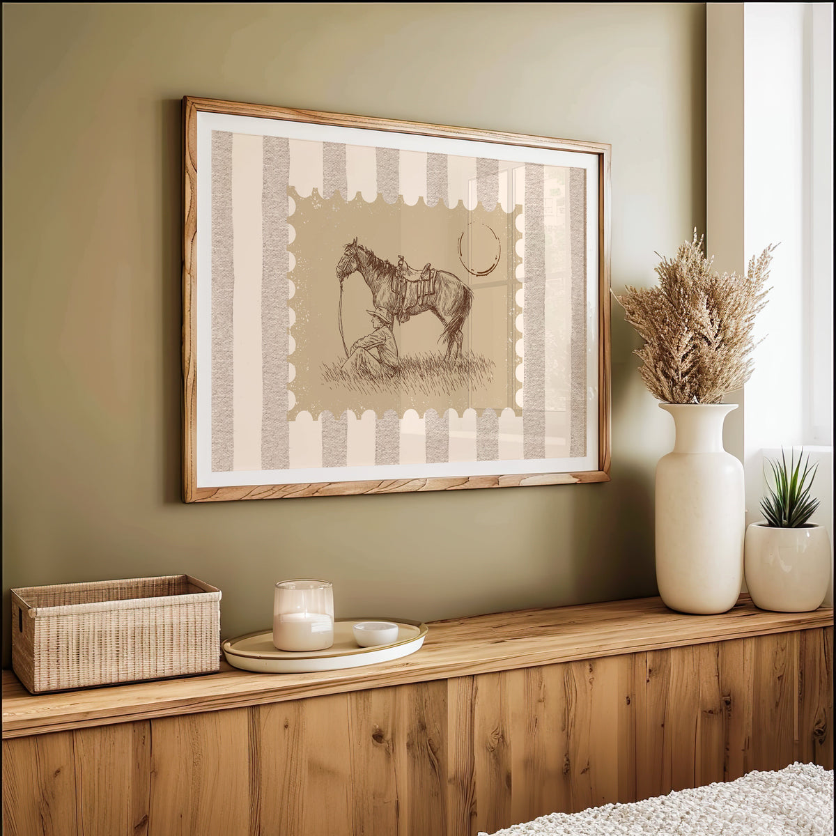 Resting horse stamp print in an oak frame on an olive green wall above pampas grass