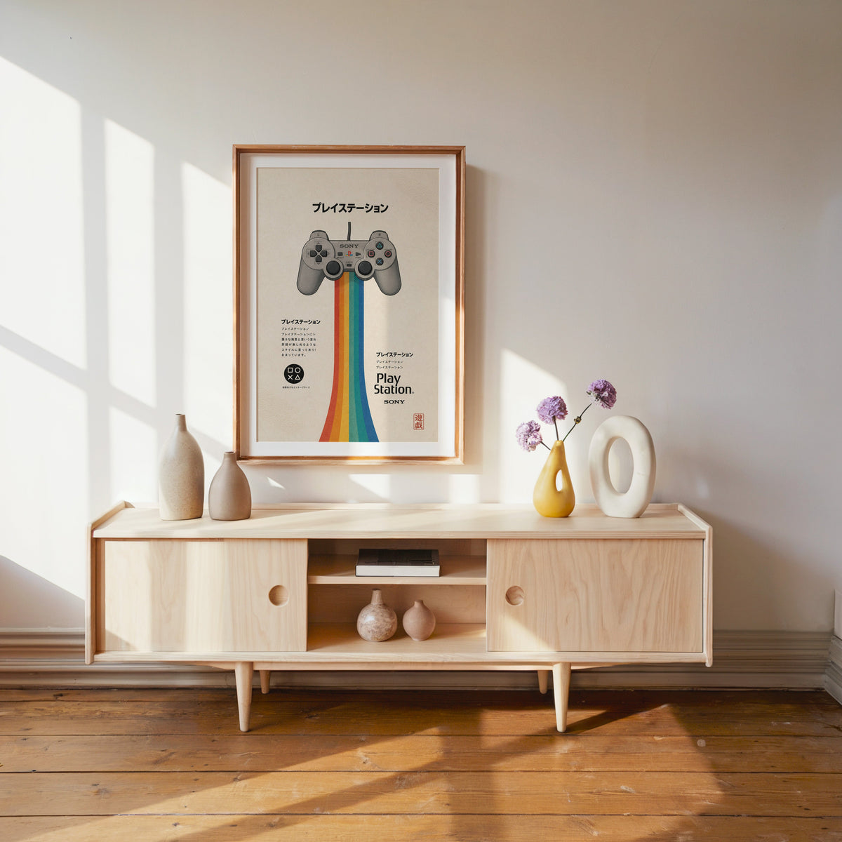 retro game controller with rainbow print shown in a wood frame with a white mat above a pale wood media console
