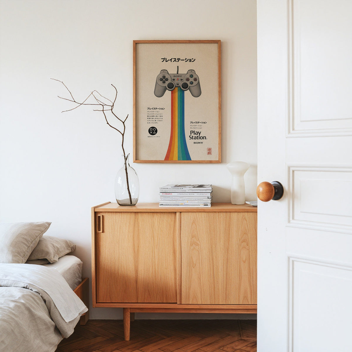 retro game controller with rainbow print in an oak frame above an oak sideboard in a bedroom with linen bedding