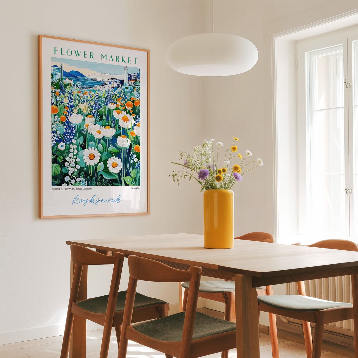 Reykjavik flower market print in an oak frame above a dining table with a yellow vase and white pendant light