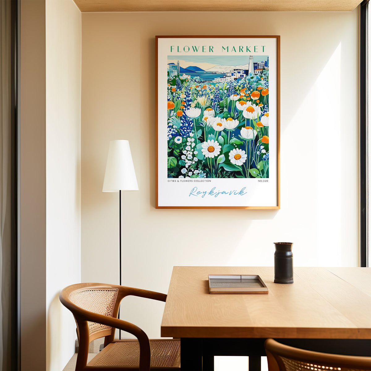 Reykjavik flower market print in an oak frame above a dining table and cane chair