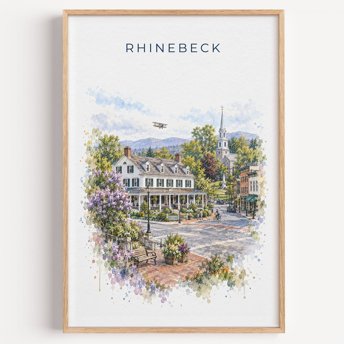 Rhinebeck, New York watercolor print in a light oak frame on a plain white wall