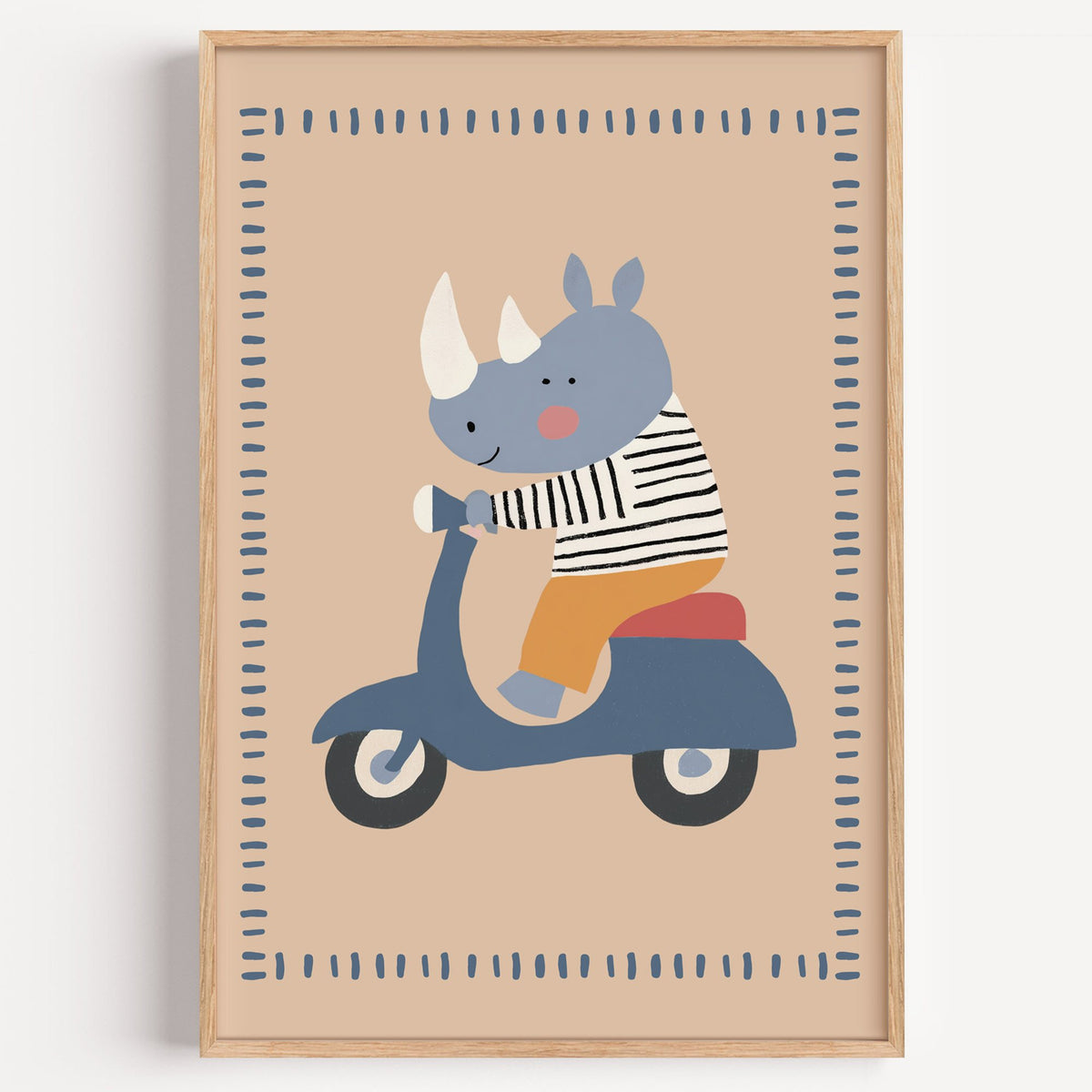 Rhino on a blue scooter nursery print in a light oak frame on a plain white wall